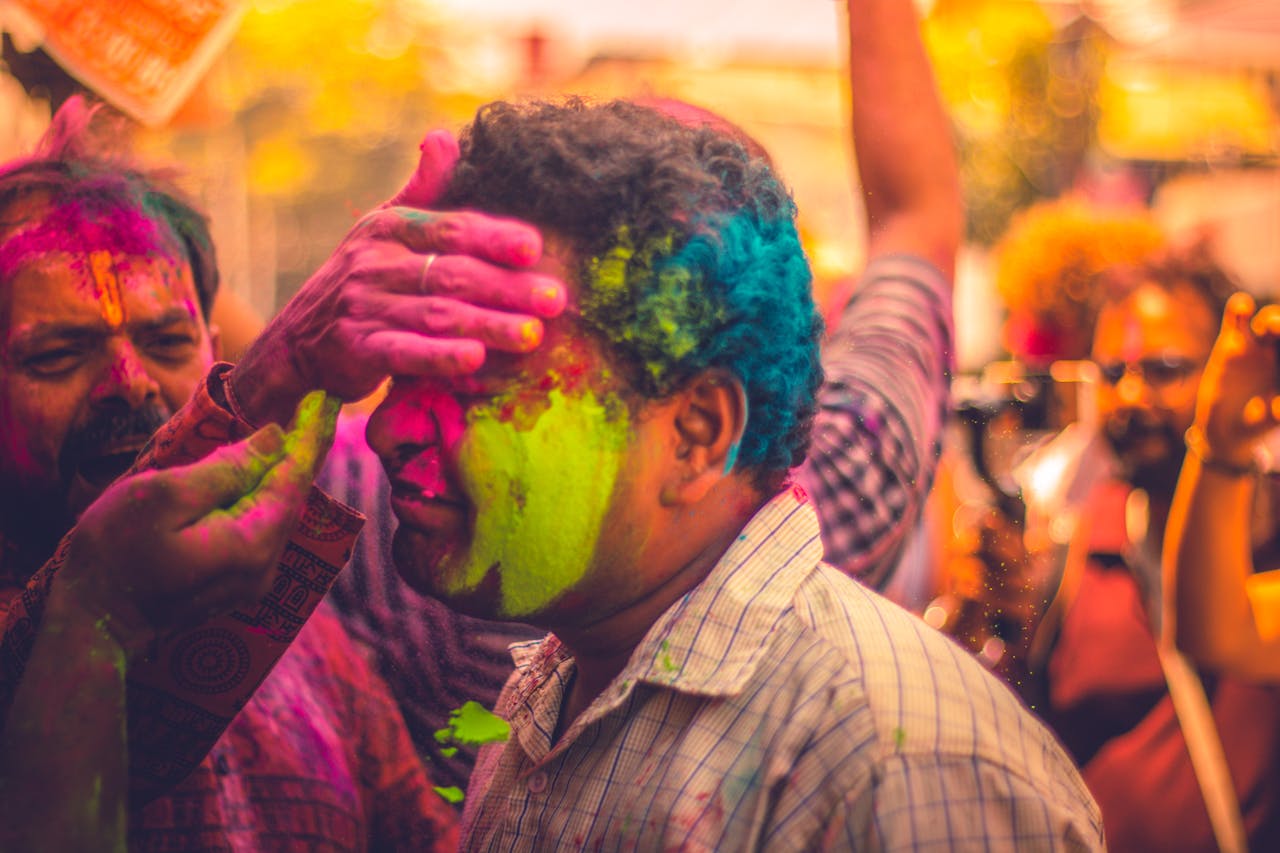 People celebrate Holi with vibrant colors in Kochi, India, showcasing joy and culture.